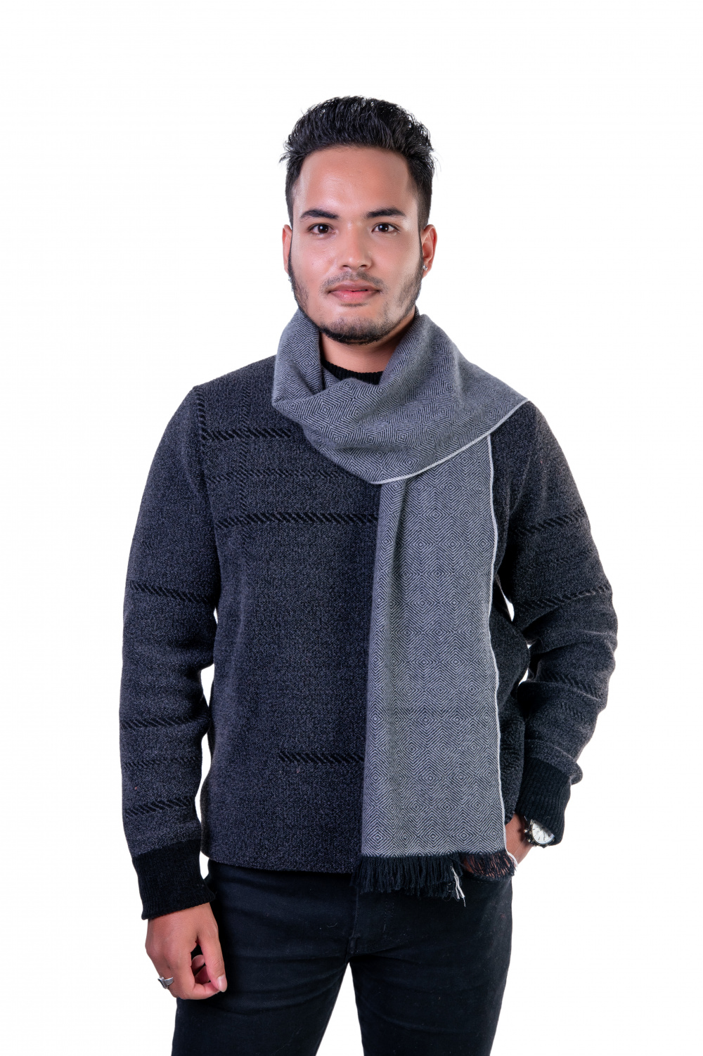 Man wearing a gray herringbone cashmere scarf, styled over a dark sweater, showcasing a versatile winter accessory.