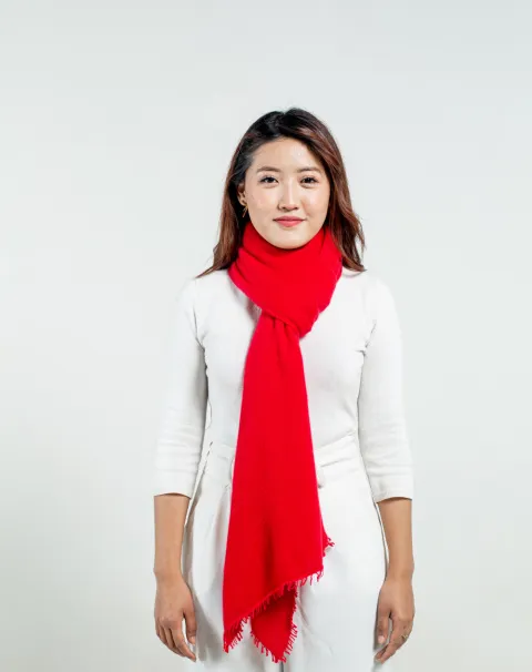 woman wearing a molten lava felted cashmere scarf tied in a simple loop knot.