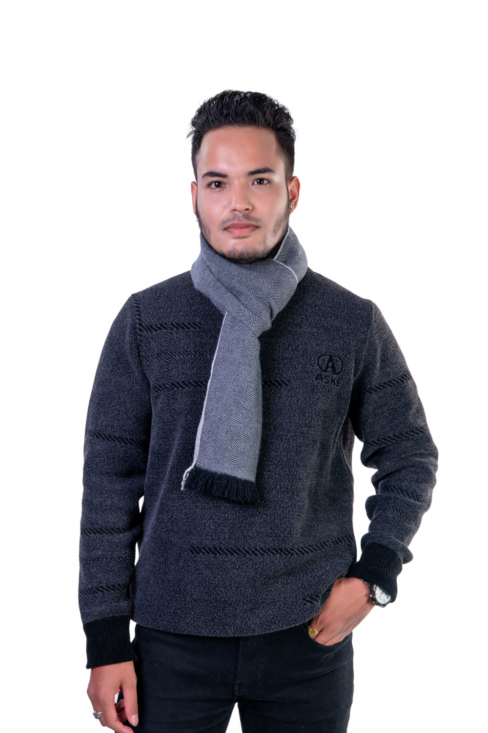 Man wearing a gray herringbone cashmere scarf, tied neatly over a dark sweater, showcasing a refined winter style