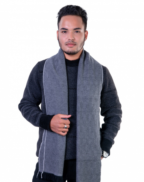 Gray herringbone cashmere scarf for men, worn over a dark sweater, showcasing a stylish winter accessory.