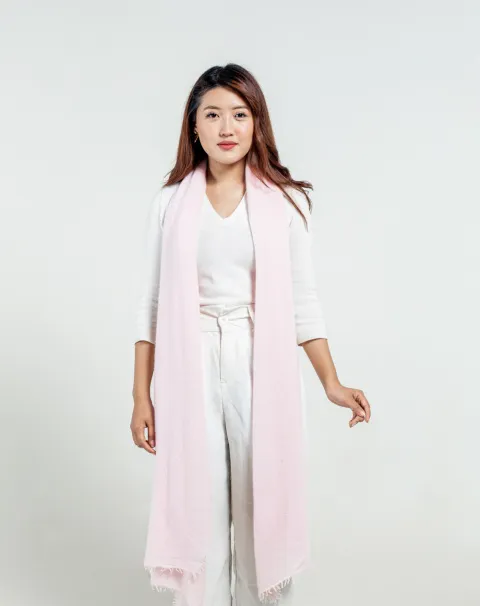  Model wearing light pink felted cashmere scarf, demonstrating its drape and styling potential.