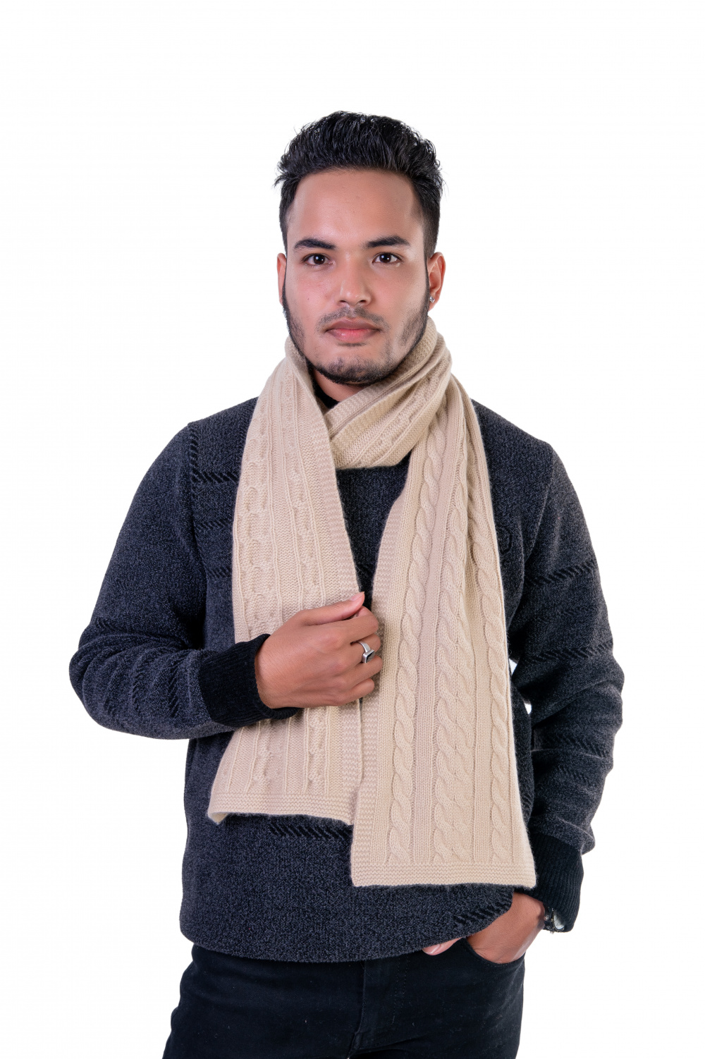 Draped beige cable-knit cashmere shawl, highlighting its warmth and exquisite craftsmanship.