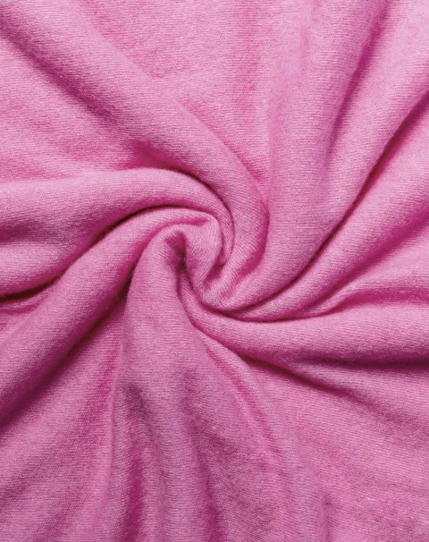 cotton candy colored soft and smooth cashmere scarf arranged in a swirl pattern.